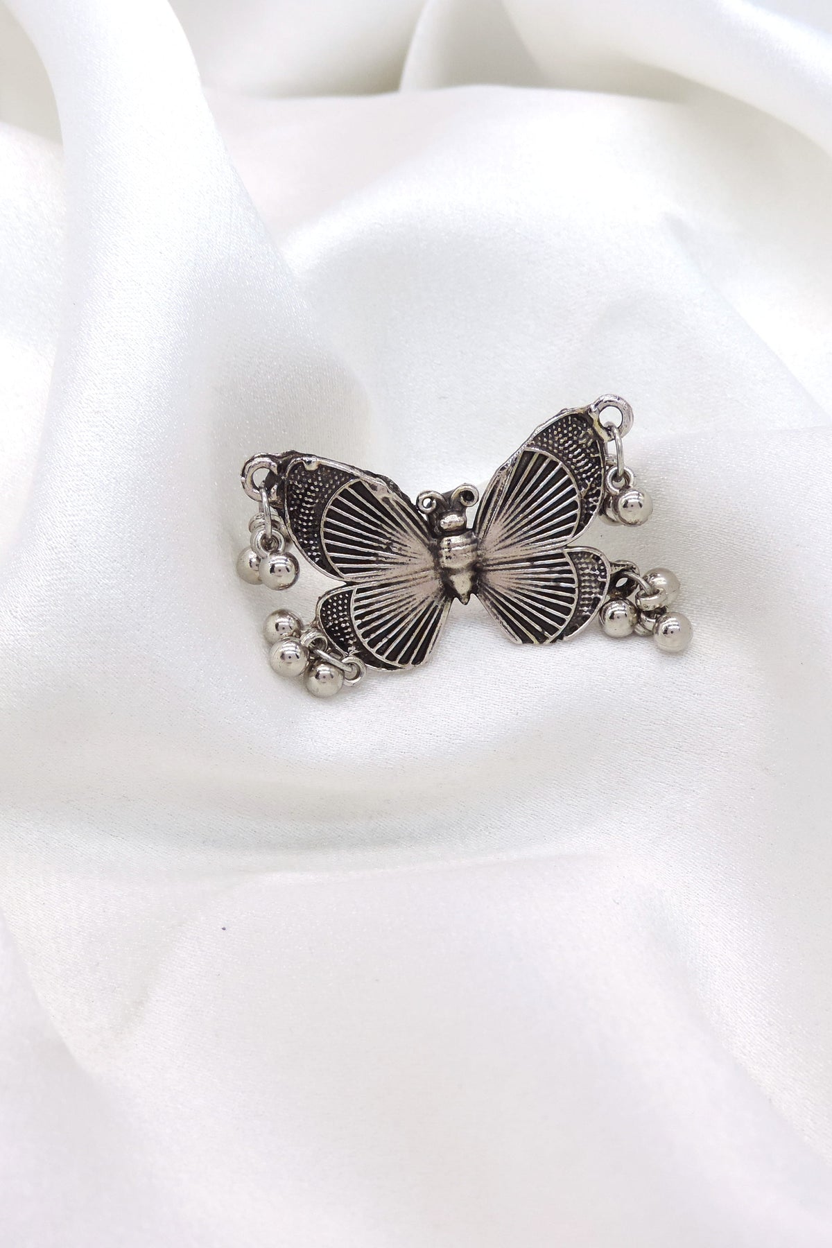 Oxidised butterfly ring with engraved detailing and dangling ghungroo beads from joyrias