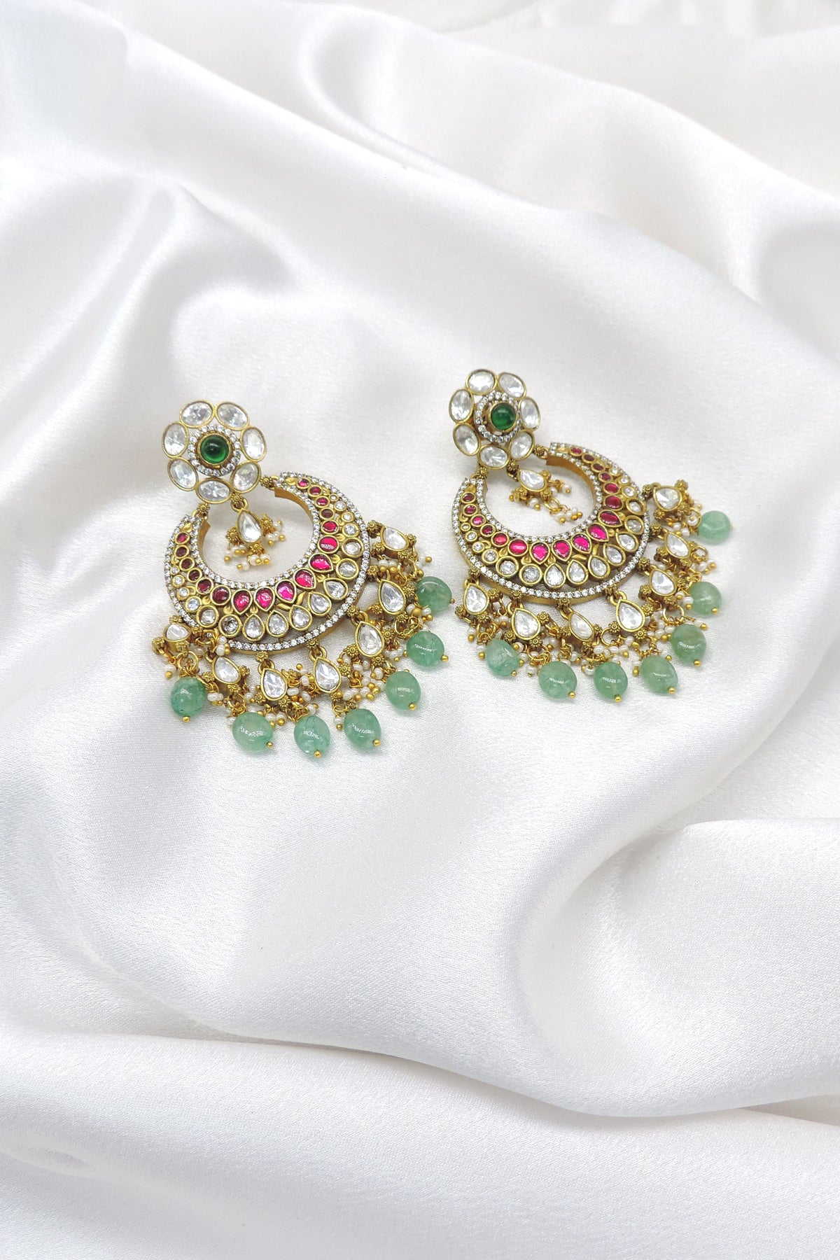 Ornate kundan chandbali earrings with pink stones and green bead drops by joyrias