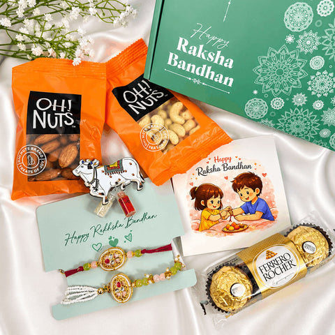 Premium Bhaiya Bhabhi Rakhi gift hamper featuring a designer couple rakhi set, almonds, cashews, Ferrero Rocher chocolates, greeting card, roli chawal set, and festive gift box for Raksha Bandhan celebrations.