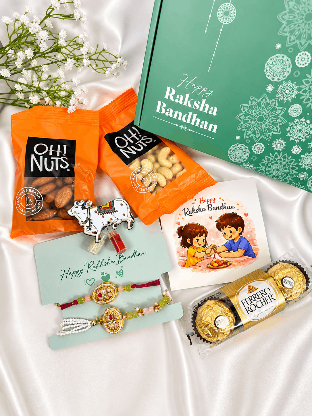 Premium Bhaiya Bhabhi Rakhi gift hamper featuring a designer couple rakhi set, almonds, cashews, Ferrero Rocher chocolates, greeting card, roli chawal set, and festive gift box for Raksha Bandhan celebrations.