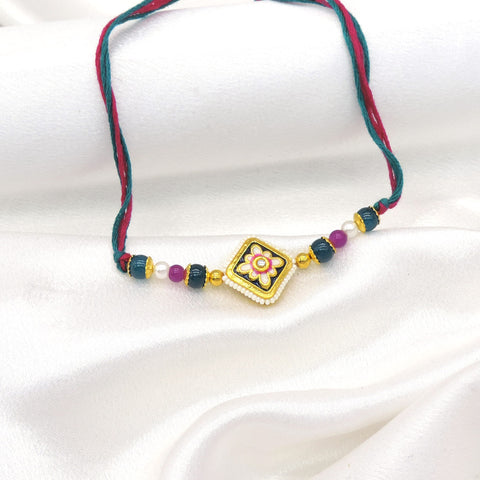 Meenakari square floral bhaiya rakhi with kundan accent and seed pearl border on teal magenta thread by Joyrias