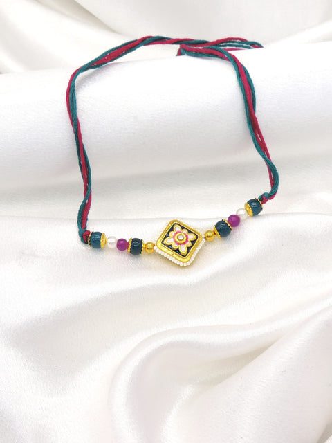 Meenakari square floral bhaiya rakhi with kundan accent and seed pearl border on teal magenta thread by Joyrias