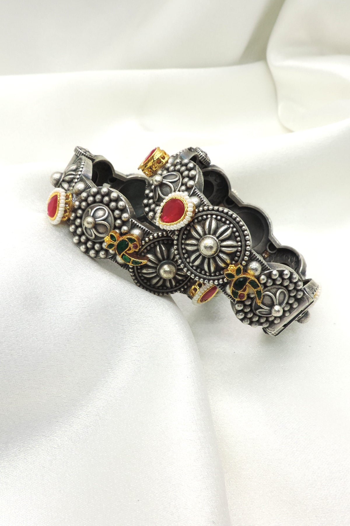 Oxidized peacock floral bangle by Joyrias