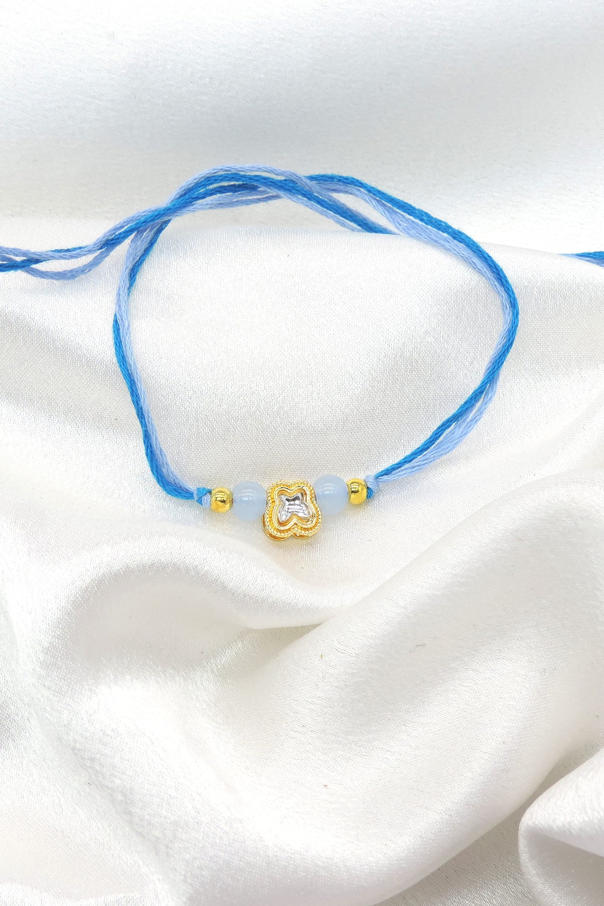 Clover charm blue bead bhaiya rakhi by Joyrias