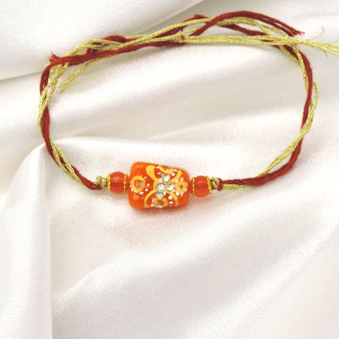Handcrafted Orange Bead Rakhi with Crystal Floral Design