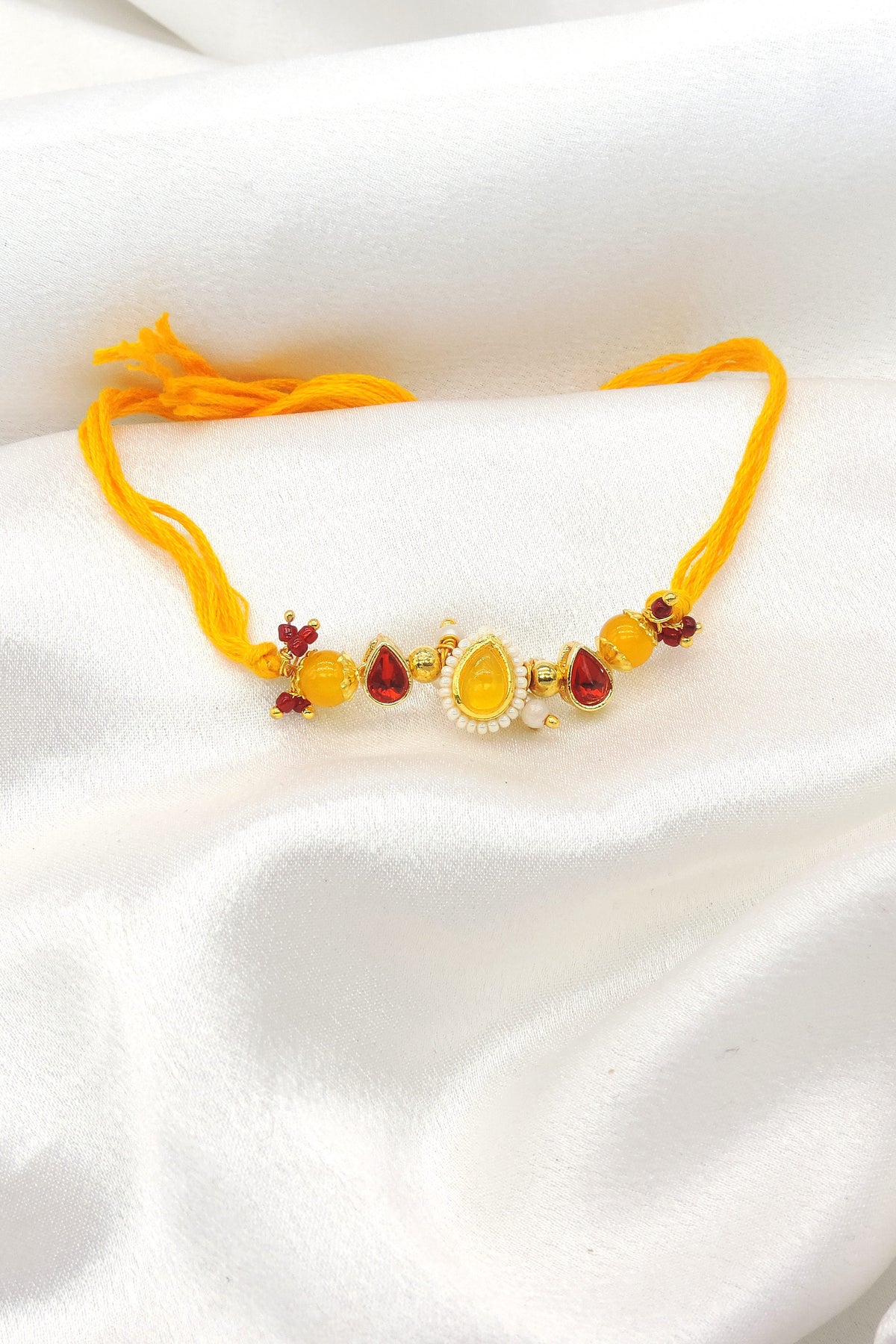 Amber teardrop pearl bhaiya rakhi by Joyrias