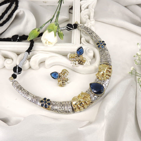 Two-tone elephant torque necklace set with blue stones and matching earrings