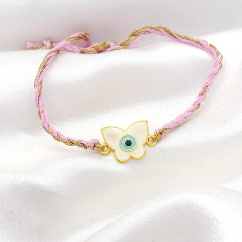 Butterfly evil eye bhaiya rakhi with white enamel charm on braided pink gold thread by Joyrias