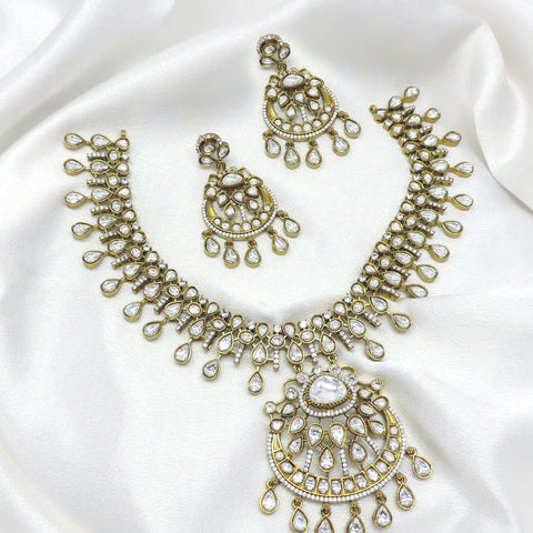 White stone kundan necklace set with matching earrings by Joyrias