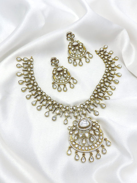 White stone kundan necklace set with matching earrings by Joyrias