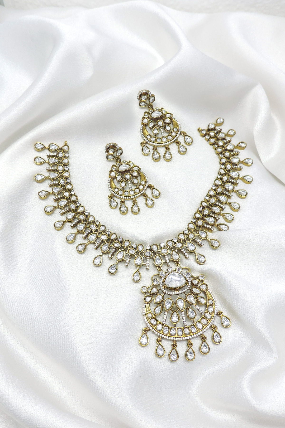 White stone kundan necklace set with matching earrings by Joyrias