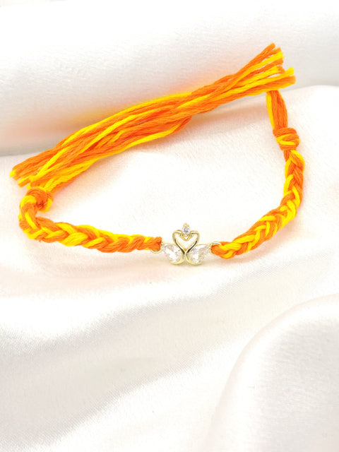 CZ swan bhaiya rakhi with gold swan duo charm and CZ teardrop wings on braided yellow orange thread by Joyrias