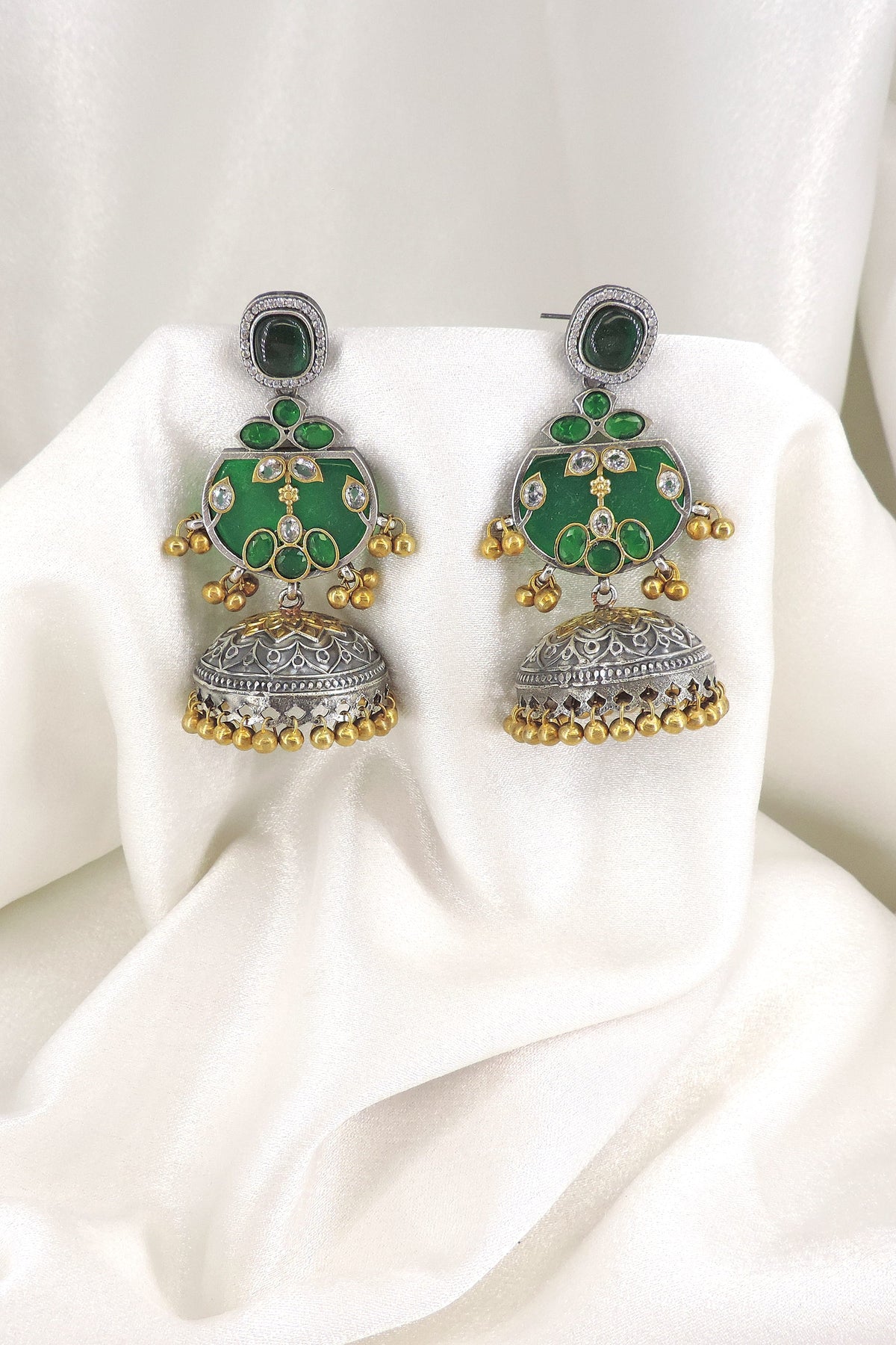 Oxidized dual-tone green stone jhumka earrings with gold-toned bead detailing by joyrias
