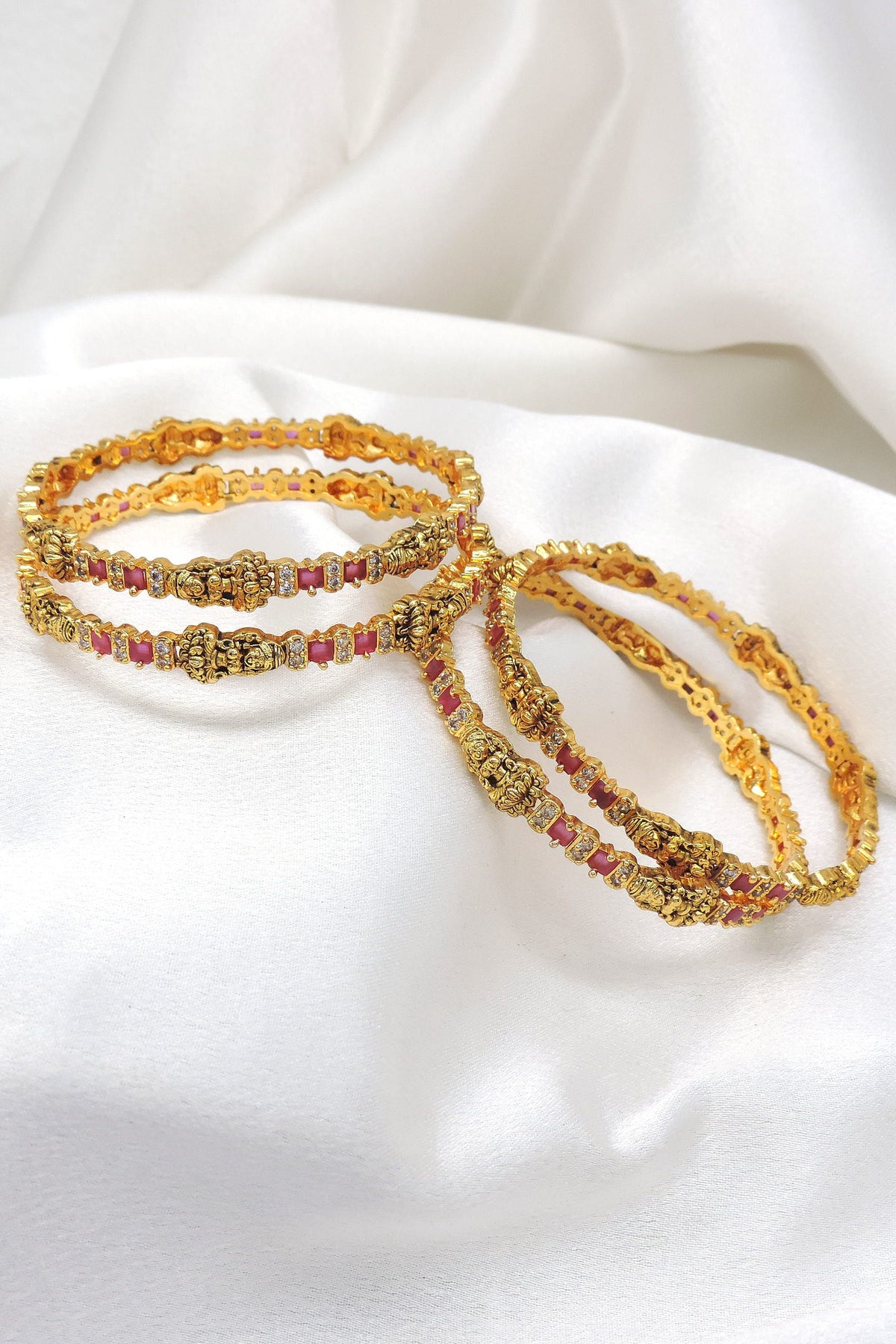 Pink gold bangle set with traditional detailing by Joyrias