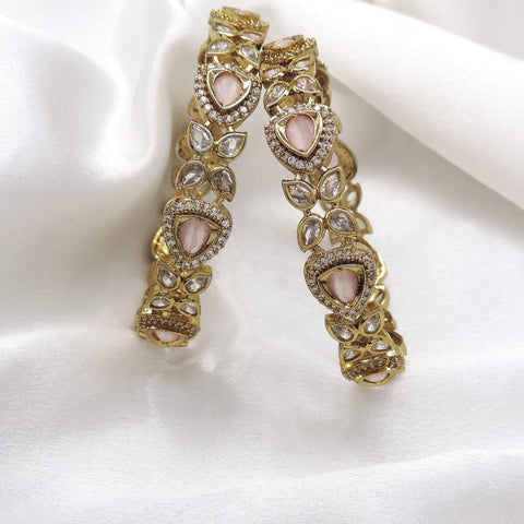 Pink stone designer bangle set with gold-tone detailing by Joyrias