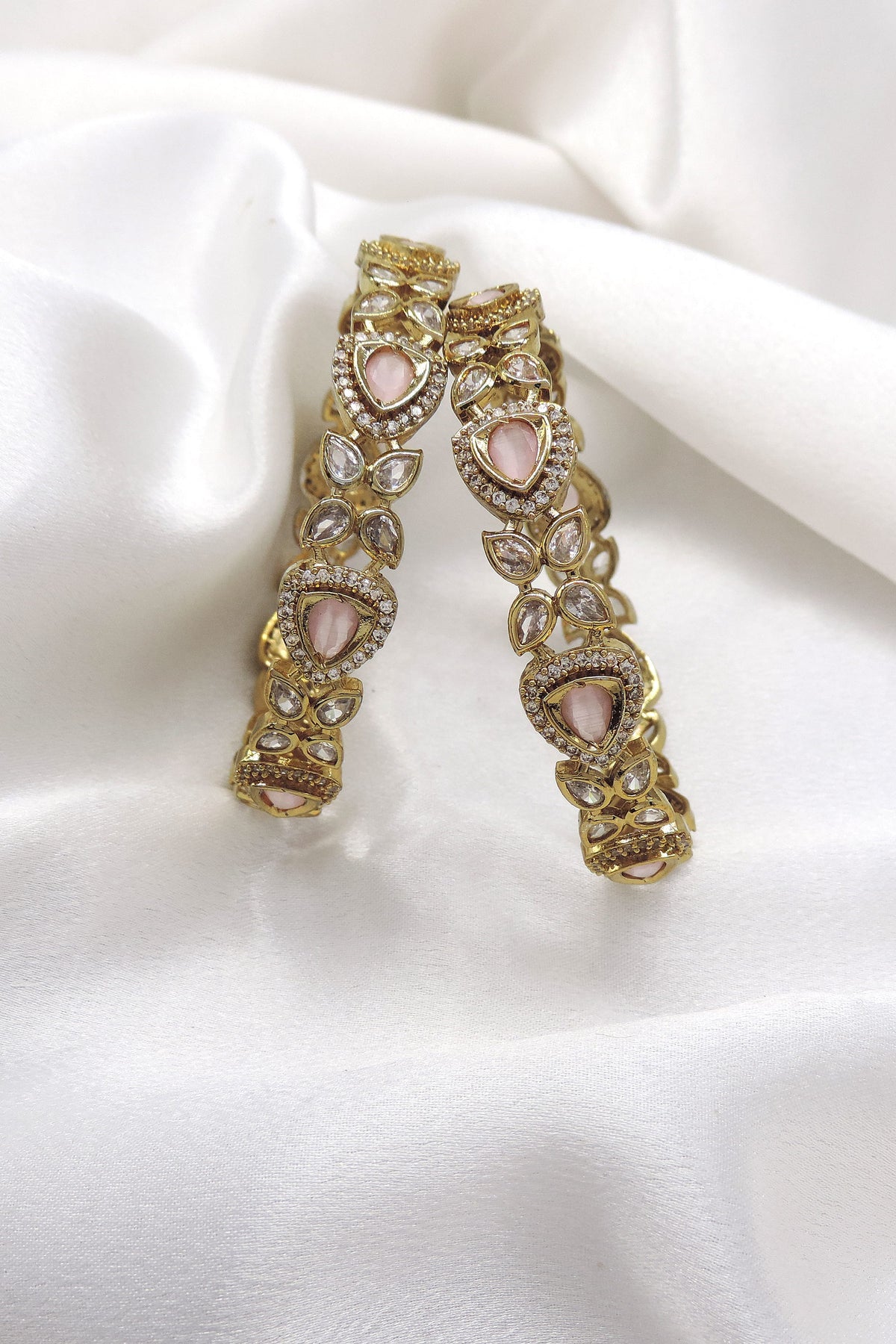 Pink stone designer bangle set with gold-tone detailing by Joyrias