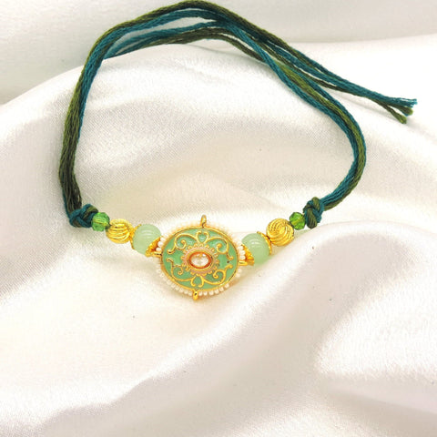 Meenakari filigree bhaiya rakhi with kundan polki and mint jade beads by Joyrias