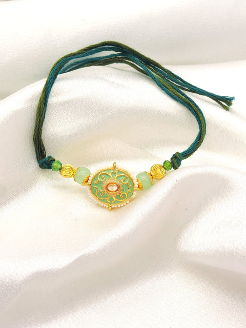 Meenakari filigree bhaiya rakhi with kundan polki and mint jade beads by Joyrias