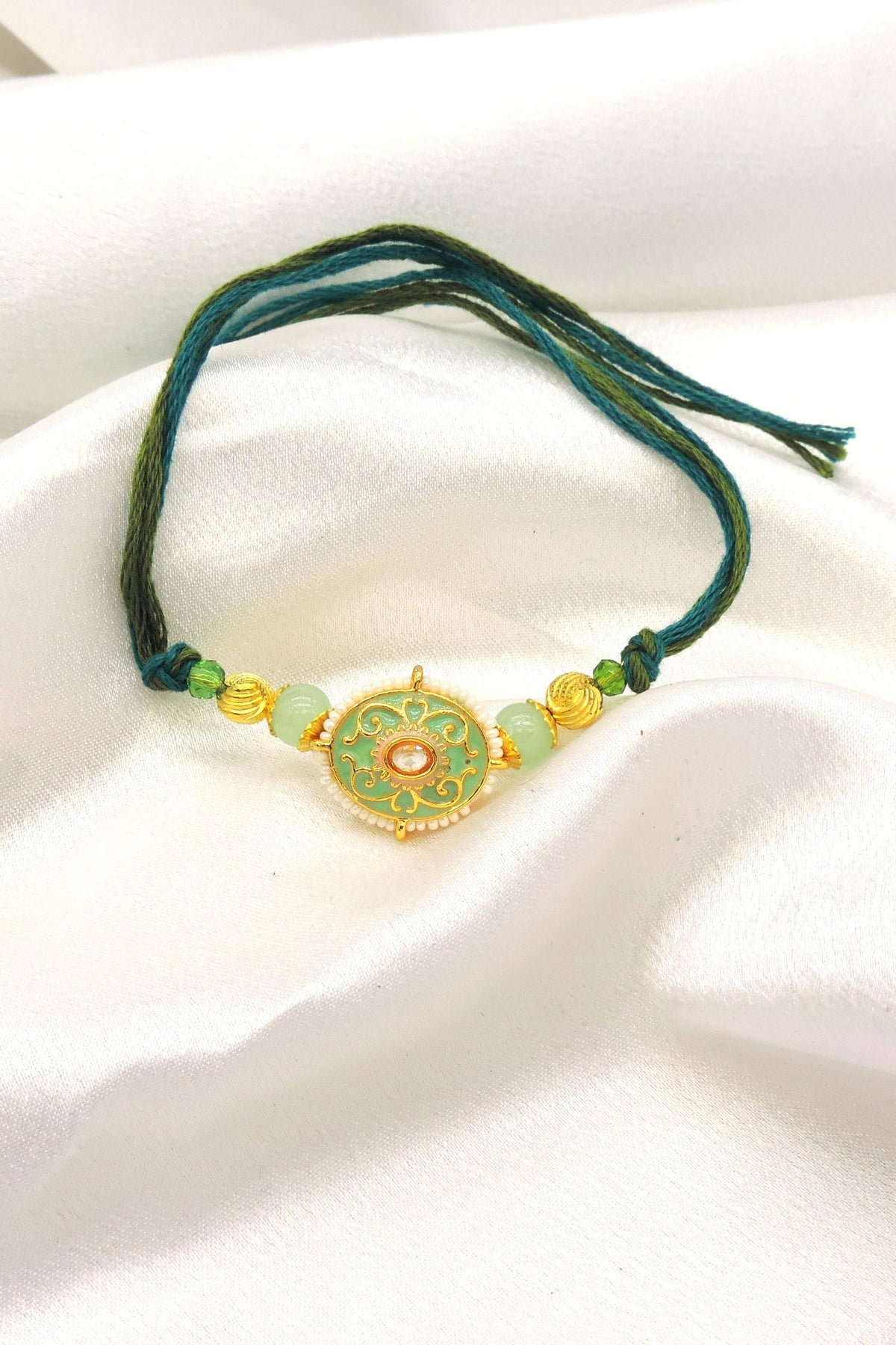 Meenakari filigree bhaiya rakhi with kundan polki and mint jade beads by Joyrias