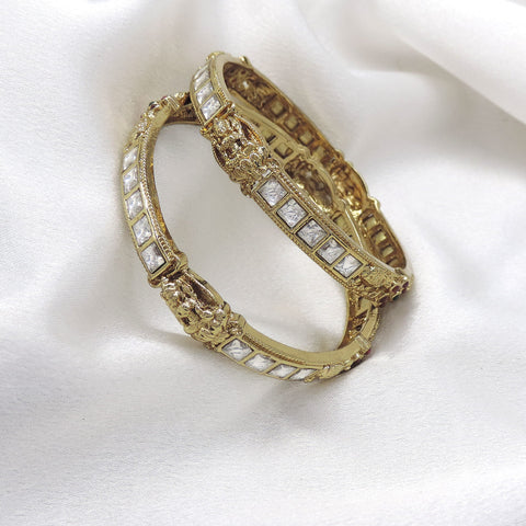White stone temple bangle set with gold-tone detailing by Joyrias