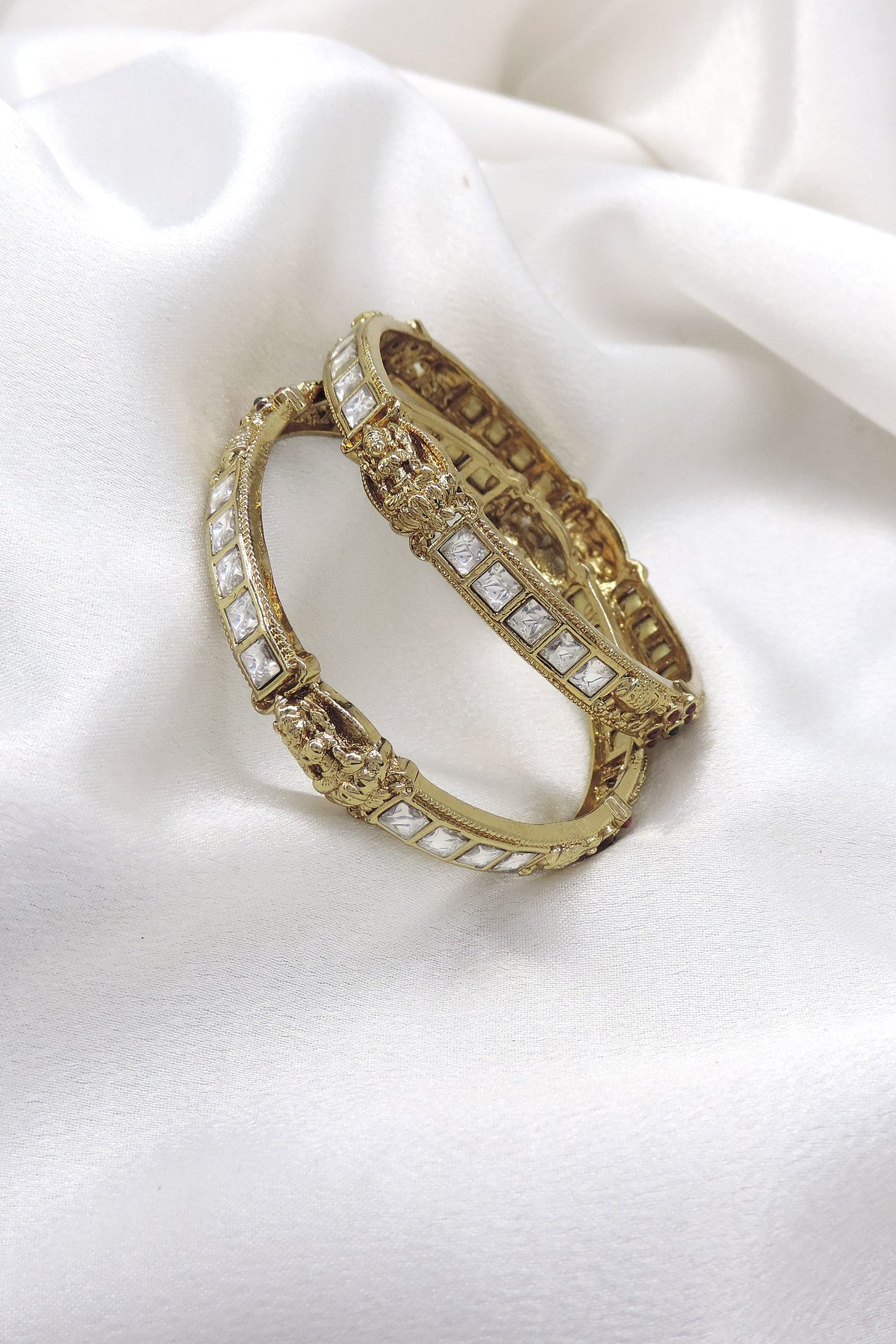 White stone temple bangle set with gold-tone detailing by Joyrias