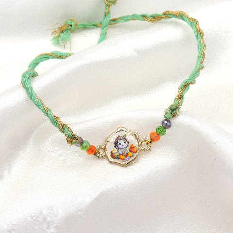 Bal Gopal Krishna bhaiya rakhi with printed Baby Krishna charm and faceted beads on mint green gold thread by Joyrias
