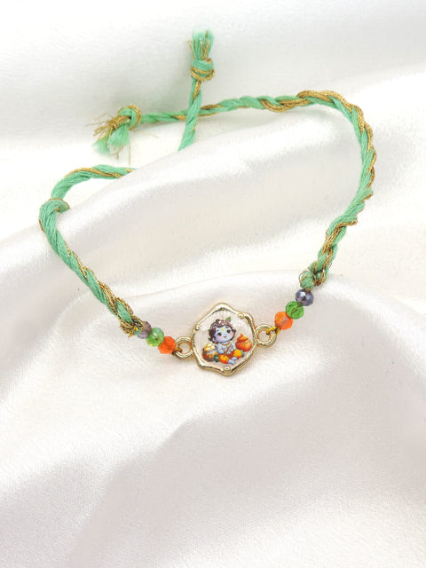 Bal Gopal Krishna bhaiya rakhi with printed Baby Krishna charm and faceted beads on mint green gold thread by Joyrias
