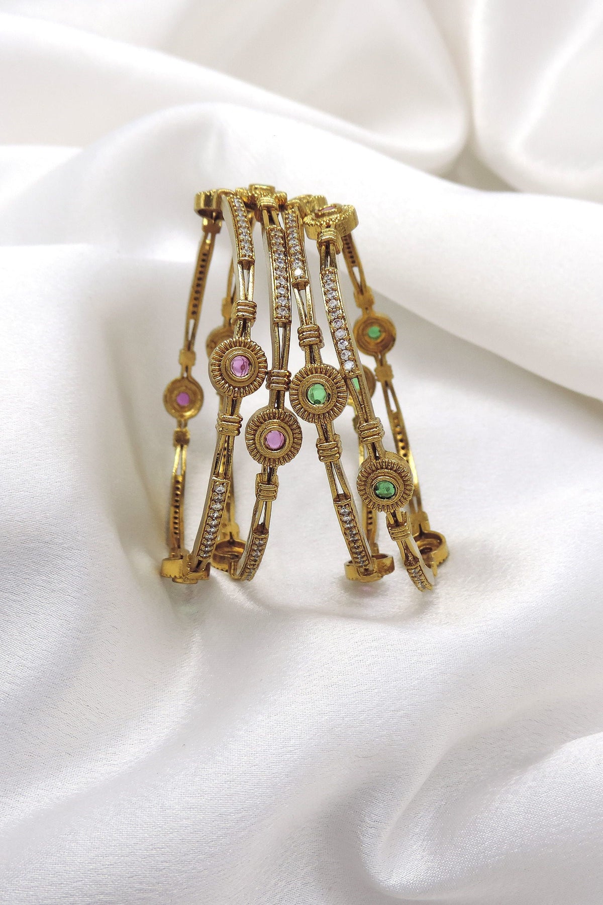 Refined gold-toned multicolor AD bangle set with pink and green stone detailing by joyrias