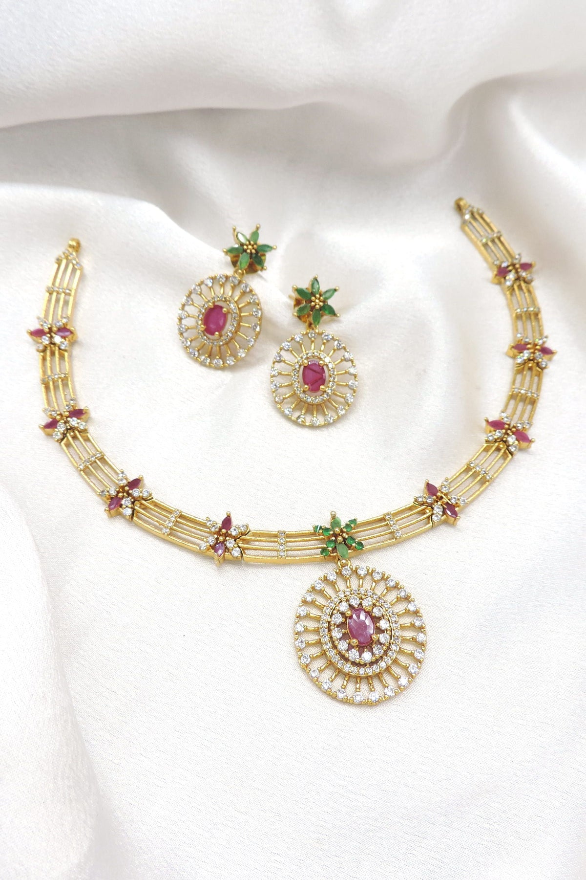 Gold tone sunburst pendant necklace set with pink and green floral accents by joyrias
