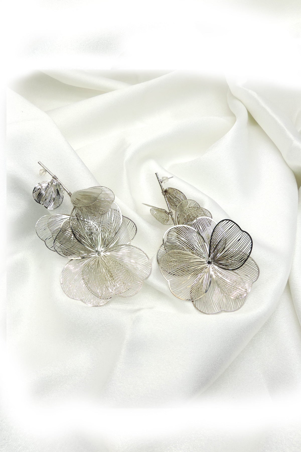 Silver floral drop earrings with layered petal design