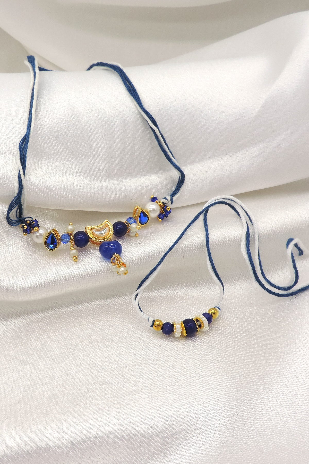 Blue stone kundan pearl bhaiya bhabhi rakhi set by Joyrias