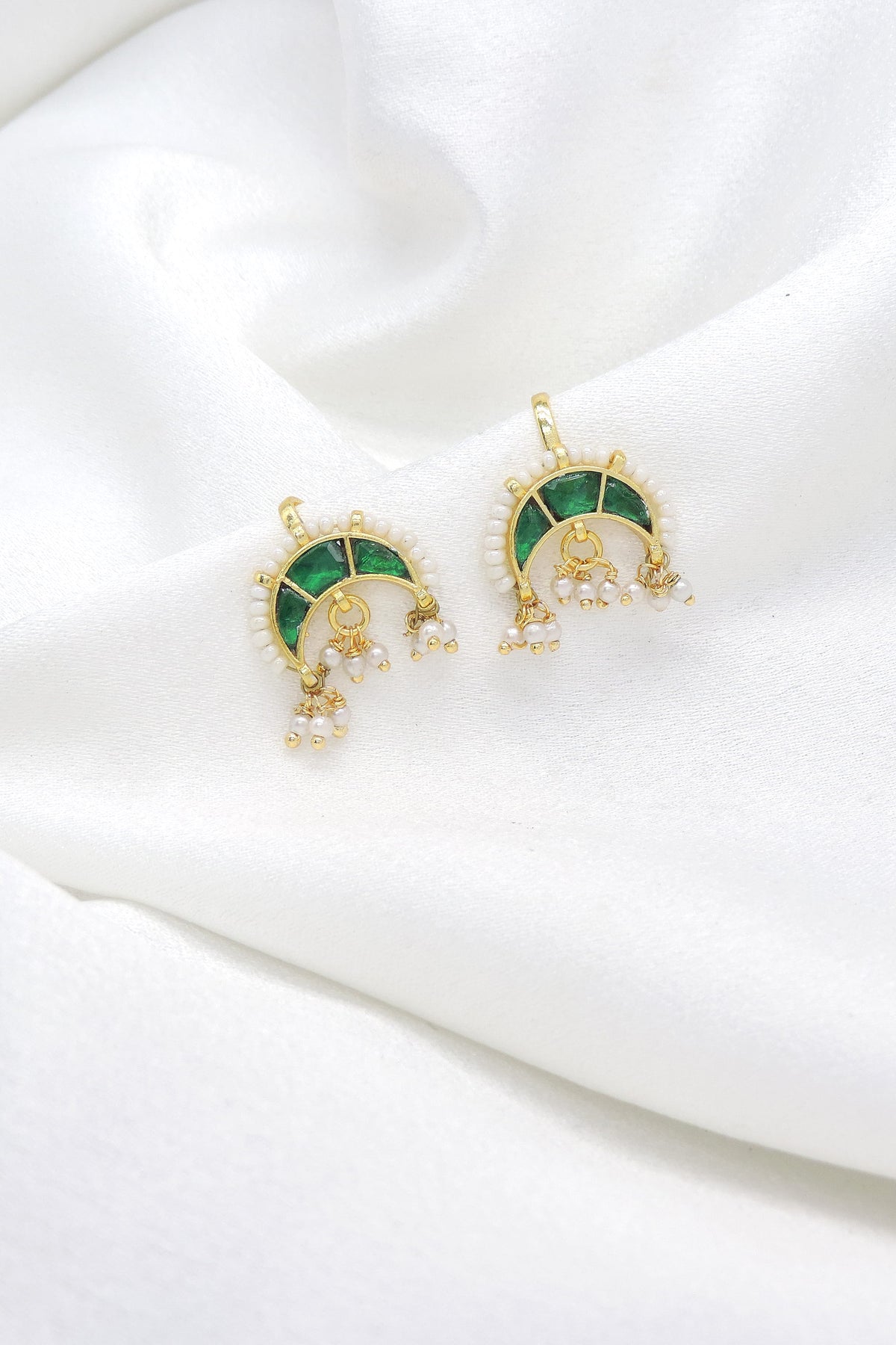 Gold-toned green stone chandbali drop earrings with white bead and pearl detailing by joyrias