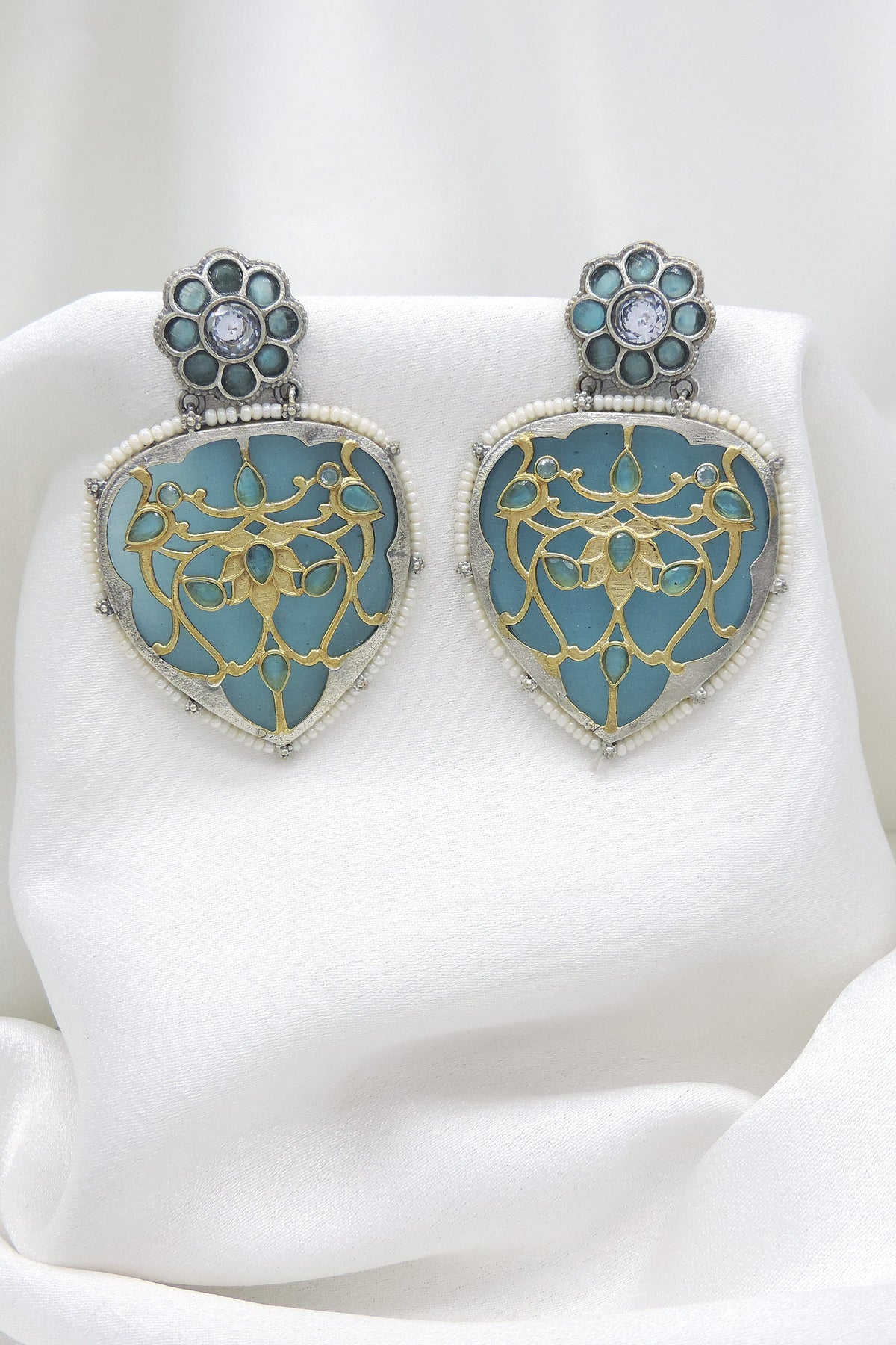 Oxidized silver blue enamel floral drop earrings with gold-toned detailing and pearl border by joyrias