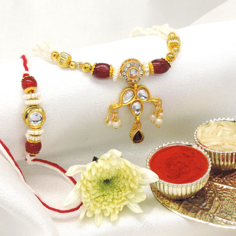Kundan drop bhaiya bhabhi rakhi set with CZ halo and pearl accents by Joyrias