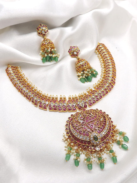 Temple royal gold-toned maroon green kundan necklace set with pearl detailing and matching jhumka earrings by joyrias
