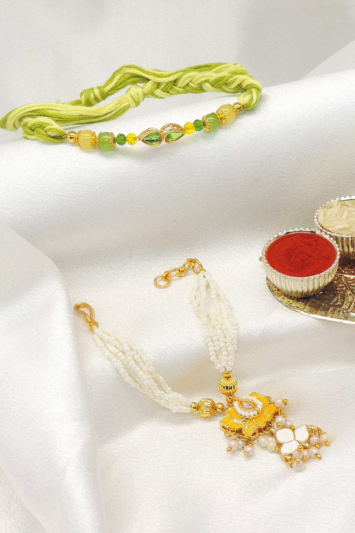 Green crystal kundan pearl bhaiya bhabhi rakhi set by Joyrias