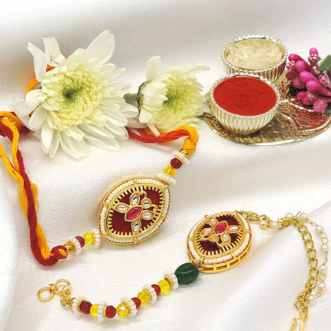 Kundan maroon enamel pearl bhaiya bhabhi rakhi set by Joyrias