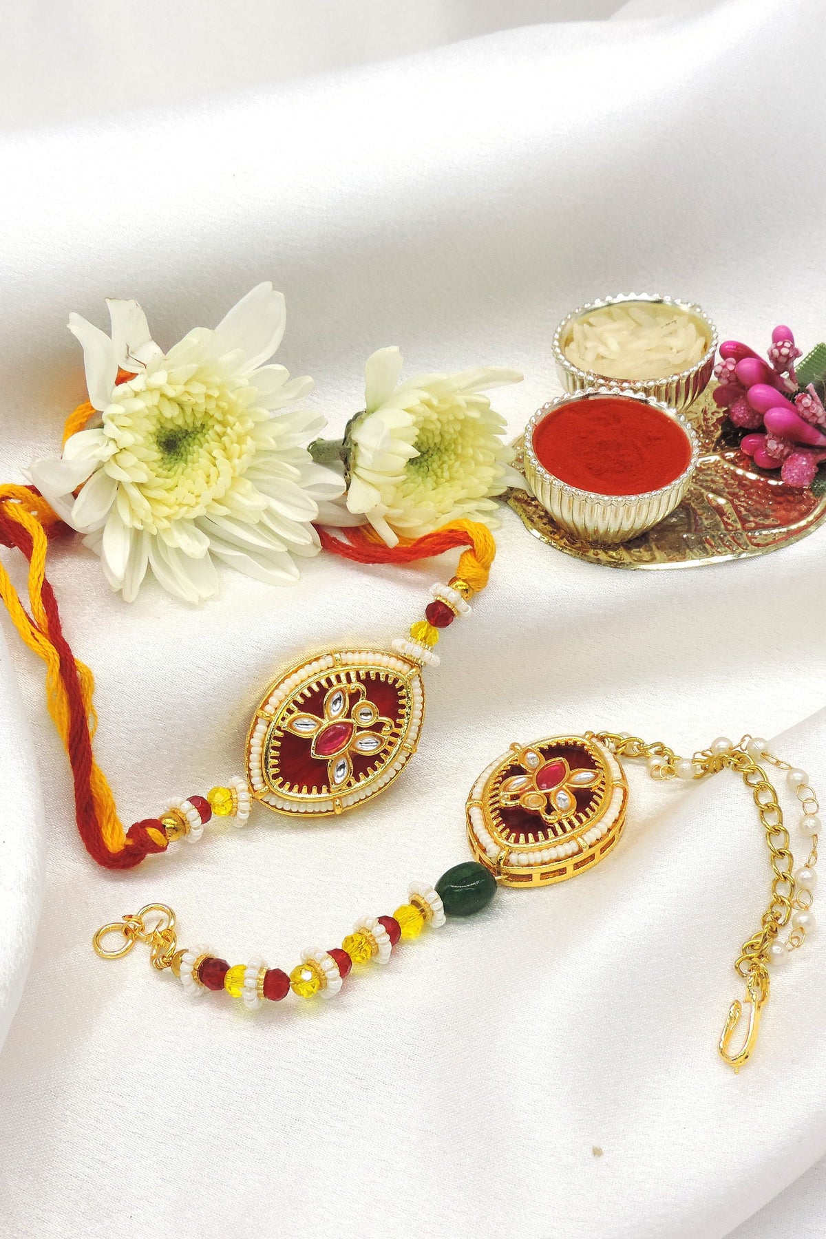 Kundan maroon enamel pearl bhaiya bhabhi rakhi set by Joyrias