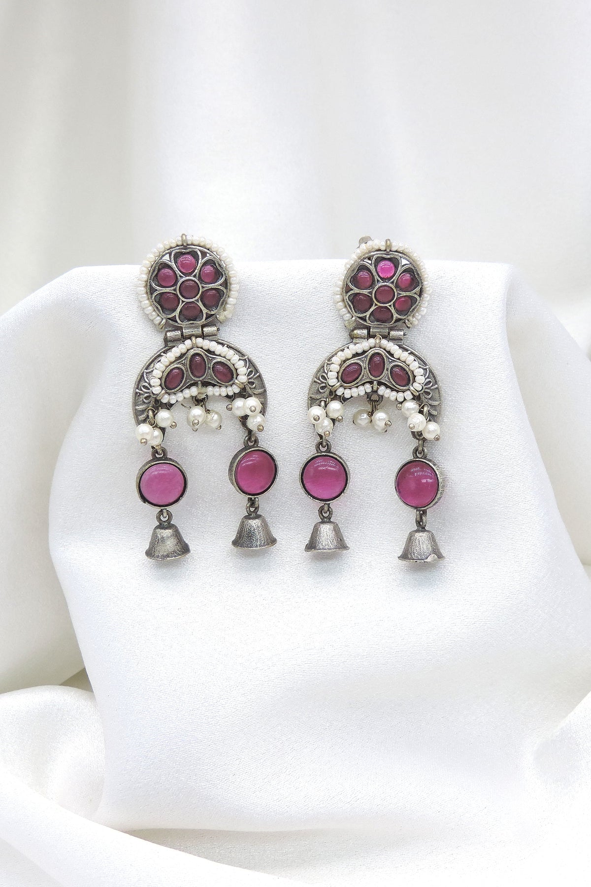 Oxidized silver pink stone double jhumka earrings with pearl detailing and silver bell charms by joyrias