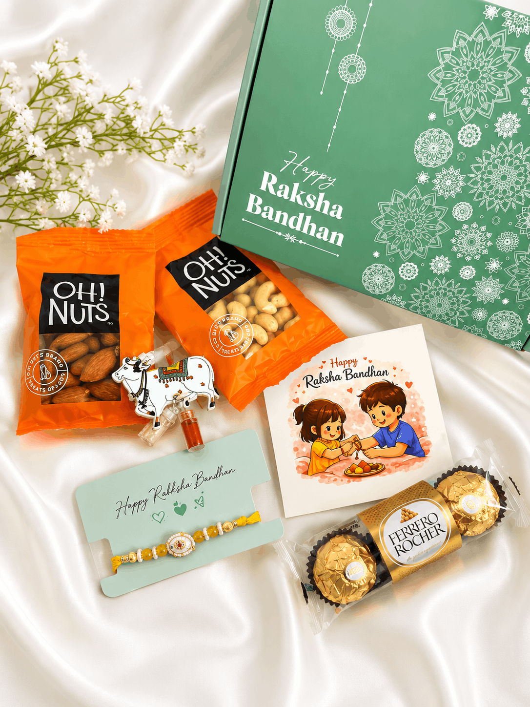Premium Rakhi gift hamper featuring a designer rakhi, almonds, cashews, Ferrero Rocher chocolates, roli chawal set, greeting card, and festive gift box for Raksha Bandhan celebrations.