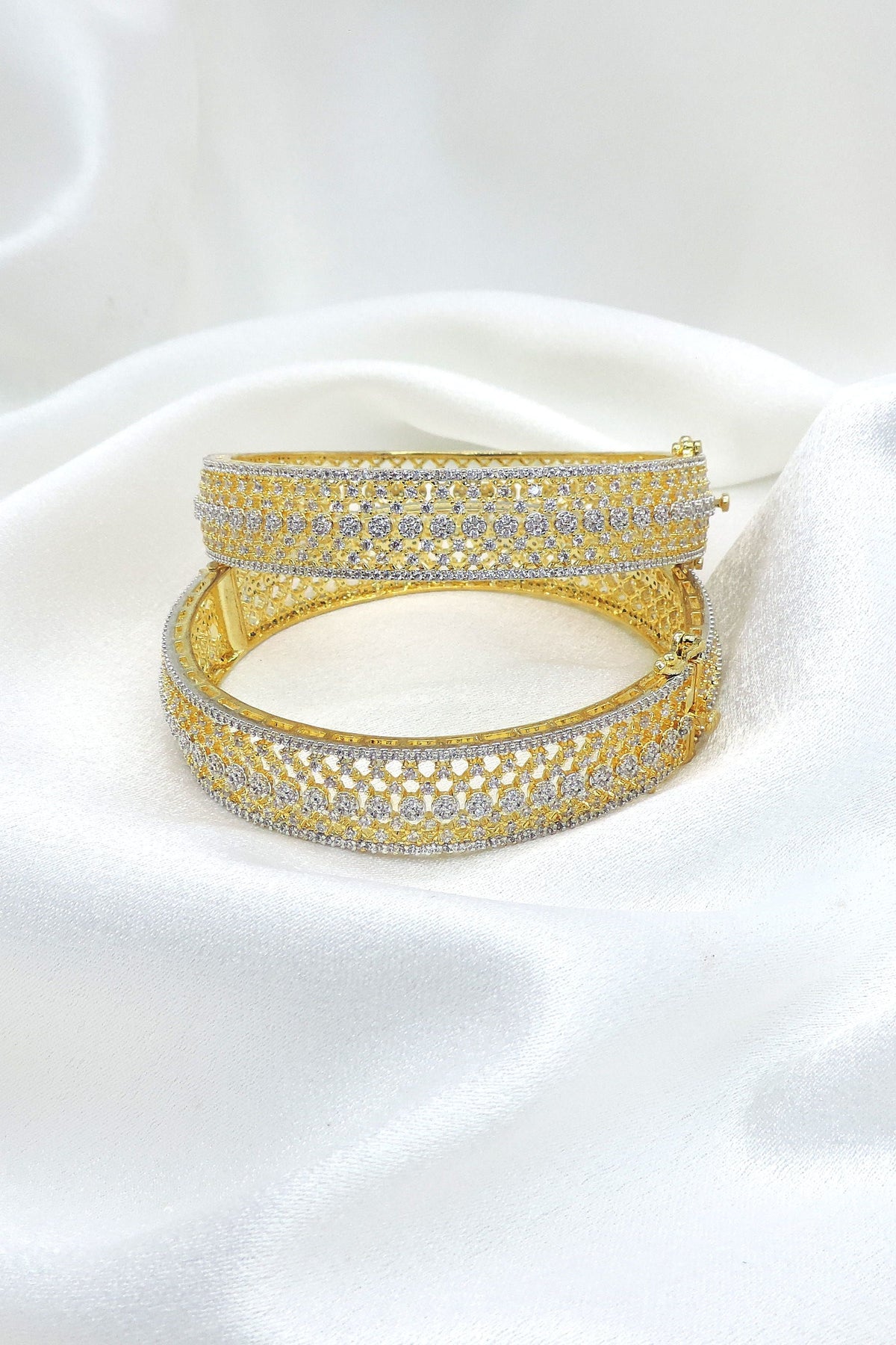 Opulent gold-toned AD wide bangle set with intricate sparkling stone detailing by joyrias