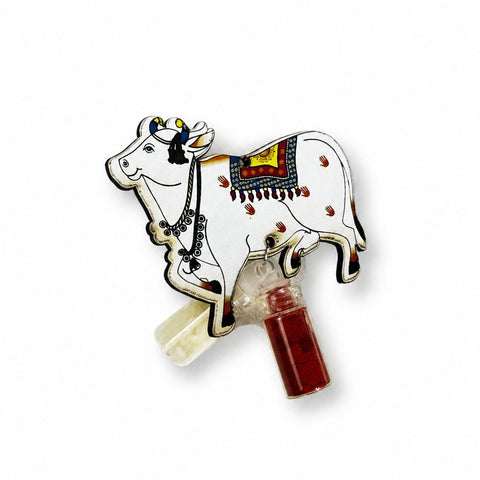 Traditional Kamdhenu Cow with included roli and chawal set for Raksha Bandhan celebrations. Perfect symbolic rakhi representing prosperity, blessings, and protection.