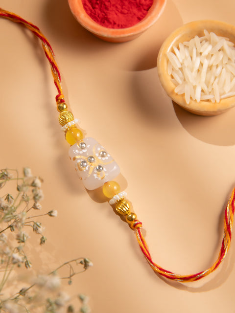 Handcrafted Orange Bead Rakhi with Crystal Floral Design