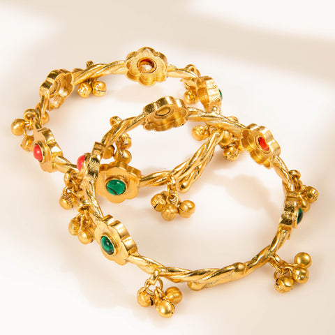 Gold-tone floral bangles set with red and green accents and ghungroo-style charms