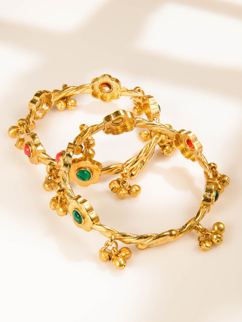 Gold-tone floral bangles set with red and green accents and ghungroo-style charms