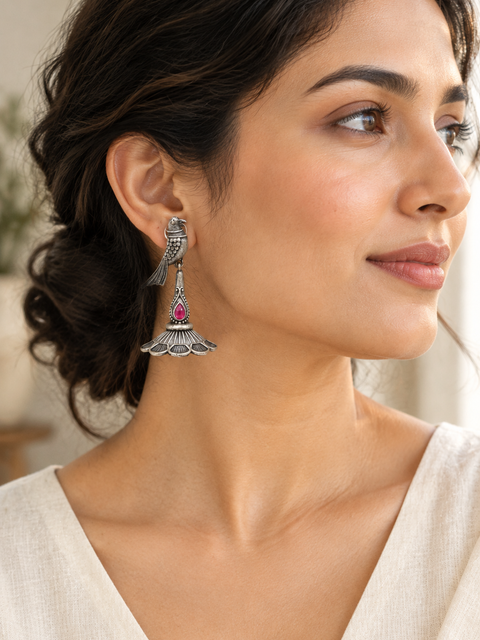 Lifestyle photo featuring the pink-stone peacock earring