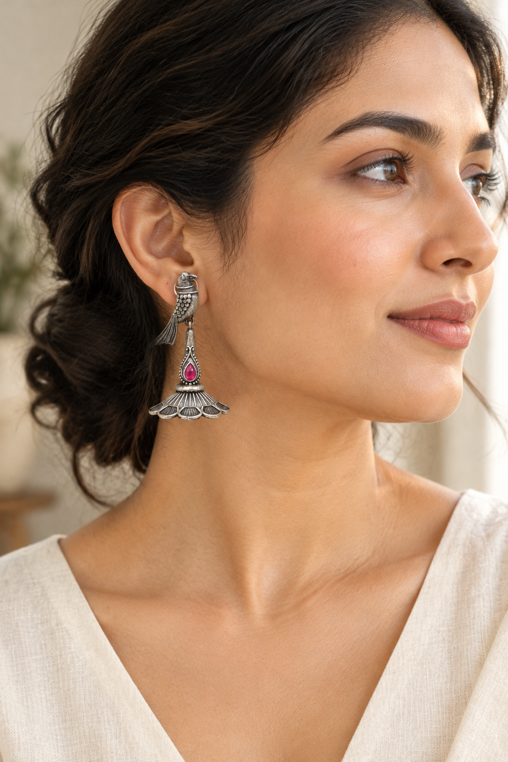 Lifestyle photo featuring the pink-stone peacock earring