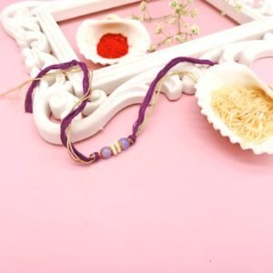 Elegant Purple Bead Rakhi – Minimalist Raksha Bandhan Thread with Golden Accents